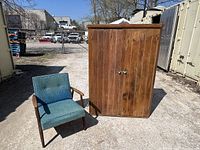Front and side view next to chair showing full cabinet dimensions and overall condition