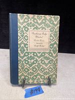 Front cover of the book titled "Gentlemen Prefer Blondes" by Anita Loos with a green patterned cover and blue spine.