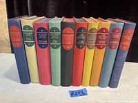 Front view of the 10 vintage books standing side-by-side showing colorful cloth bindings and gold embossed titles.