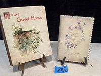 Two antique books on stands with visible wear