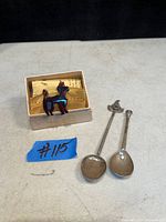 Photo shows two sterling silver spoons and a vintage poodle-shaped brooch with a tortoise shell body, displayed in a small box.