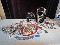 Wide overview of assorted jewelry on table