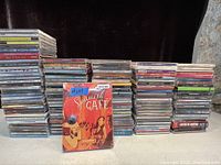 Front view showing multiple stacks of CDs including prominently displayed Spanish Café 3-CD set with price tag $14.99