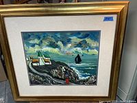 Framed oil painting showing coastal scene with white houses, a figure, and sailboats on ocean, signed J. Kelly.