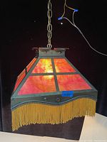 Front and side views of the antique Arts & Crafts ceiling fixture showing stained glass and brass chain