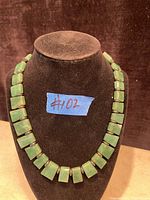 Jade & sterling silver Art Deco necklace displayed on a black velvet bust, showing front view