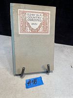 Front cover of the book showing grey-green cover with decorative title label