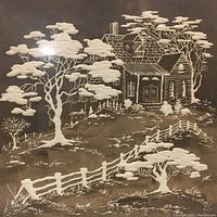 Close-up of the 3-D etching artwork showing detailed scene of house, trees, and fence in white on dark background.