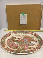 Large turkey platter in front of original cardboard box, showing full view with measuring tape indicating size.
