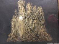 Close-up of brass rubbing showing Alice Avenyng and daughters in gold on a black background with fine details and framed in wood.