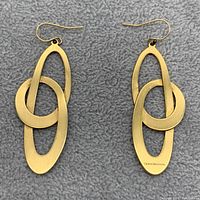 Front view of both earrings laid flat on grey background