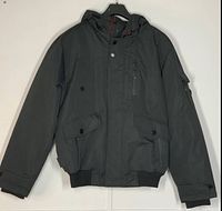 Front view of the black NOIZE bomber jacket with hood, showing zip, flap chest pockets, and ribbed hem and cuffs.