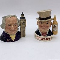 Two Royal Doulton Toby mugs shown side by side, front view, showcasing John Doulton mug with Big Ben and Dewars White Label mug with bottle.