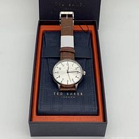 Top view of Ted Baker watch in original box showing brown leather strap and silver-tone dial with Ted Baker branding on interior box.