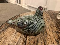 Side view of bird sculpture showing swirl pattern and body profile