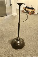 Full view of the pendant lamp showing the entire length, the cylindrical rod, and the upper ceiling mount with cord.