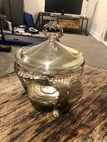 Front and side view of the vintage silver plated chafing dish showing detailed legs and lid handle.