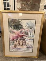 Framed print of cherub fountain in gold frame, showing full artwork and frame.