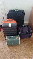 Four travel bags together, showing size and color variations