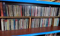 Photo of two shelves filled with music CDs, mostly classical and opera genres. Arranged in standard jewel cases and boxed sets.