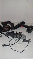 Three power tools shown together including Craftsman cordless drill with charging base, Goxawee 20V cordless drill, and Galaxy Pro 8622 corded tool.