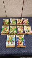 Front view of 10 Legend of Zelda comic books laid out in two rows showing colorful illustrated covers featuring Link and other characters.