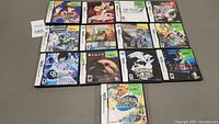 Group shot of 13 Nintendo DS game cases arranged on table.