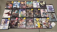 Overview of all 17 PS2 game cases arranged on table
