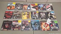 Top-down view showing all 18 PS3 game cases laid out in rows, titles and cover art visible.