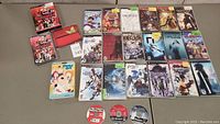 Grid of PSP UMD game and soundtrack cases laid out on tabletop