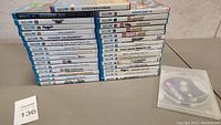 Two stacks of Wii U game cases and a clear plastic disc binder on a table
