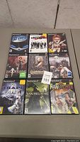 Top view of 9 PS2 games spread in a 3x3 arrangement showing titles and cover art.