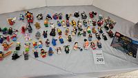 All figures laid out on cloth backdrop