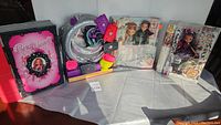 Full lot overview showing Briar Beauty book, doll play set, bags, and boxed dolls