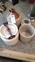 Photo showing all four items: one large ceramic jug and three ceramic crocks of varying size, one with clamp lid.