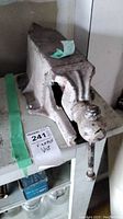 Front view showing fixed jaw, sliding jaw and screw handle attached to mounting base