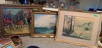 Three framed art pieces: Hunting scene, ocean ship oil painting, and a forest landscape.