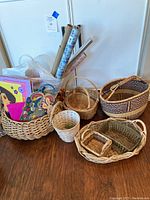 Overall shot of baskets with wrapping paper rolls and children's paper items visible