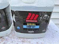Close-up of Motomaster Diesel Exhaust Fluid jug label showing brand, product type, and capacity