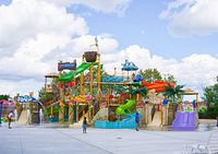 Exterior view of multi-level water play structure with slides and tipping bucket