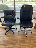 Front view of two office chairs showing their seat and backrest design, color, and condition