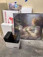 Overall lot showing foam core boards in a box, art print and foam core board packaging boxes.