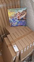 Front of canvas print depicting Ariel from The Little Mermaid displayed on stacked cardboard boxes