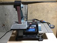 Delta belt and disc sander showing belt upright and disc sanding table.