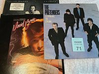 Photo of three vinyl album covers: Julian Lennon 'Valotte', David Bowie 'Young Americans', and The Pretenders 'Learning to Crawl'