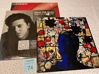 Photo showing all three album covers: Loverboy, Tears For Fears 'Songs From The Big Chair', and David Bowie with floral pattern and blue tinted face.