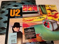 Front album cover showing three albums: Tommy by The Who, U2's album, and A Flock of Seagulls with a colorful surrealistic cover.