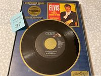 Framed platinum record of Elvis Presley's "Suspicious Minds" showing the vinyl record with gold RCA label and framed artwork.