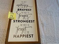 Full view of the 10x19 wall hanging showing the inspirational saying in black and brown text on white background with a wood frame.