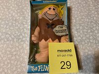 Front view of Barney plush doll inside original Knickerbocker Flintstones box showing torn plastic and box wear.